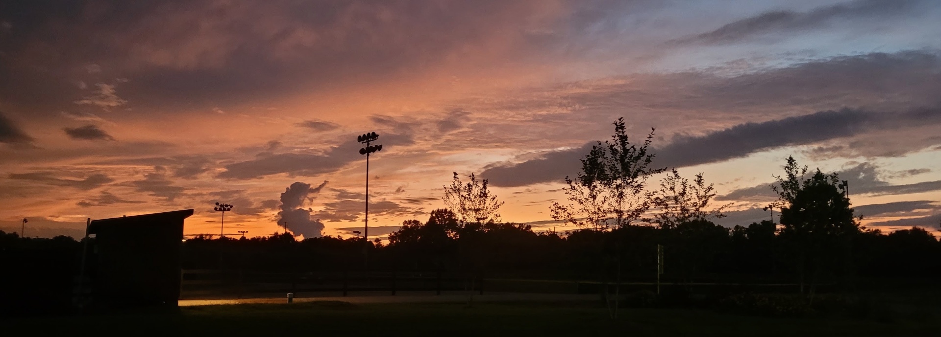 Arena lights against the dusk